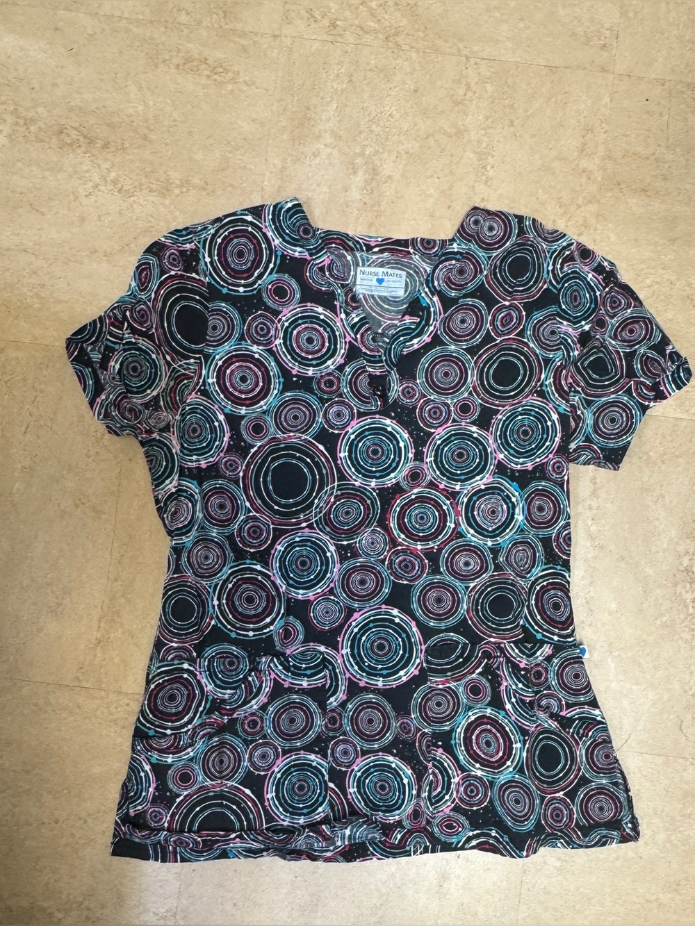 Nurse Mates' medium scrub top with abstract swirl pattern